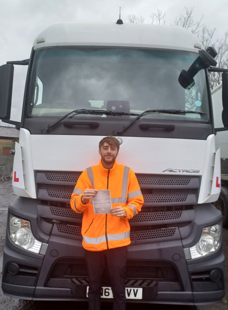 A photo of Zak with his certificate after his 3A first time pass.