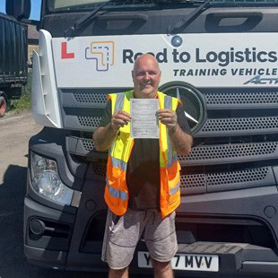 A photograph of Lee S proudly holding his pass certificate.
